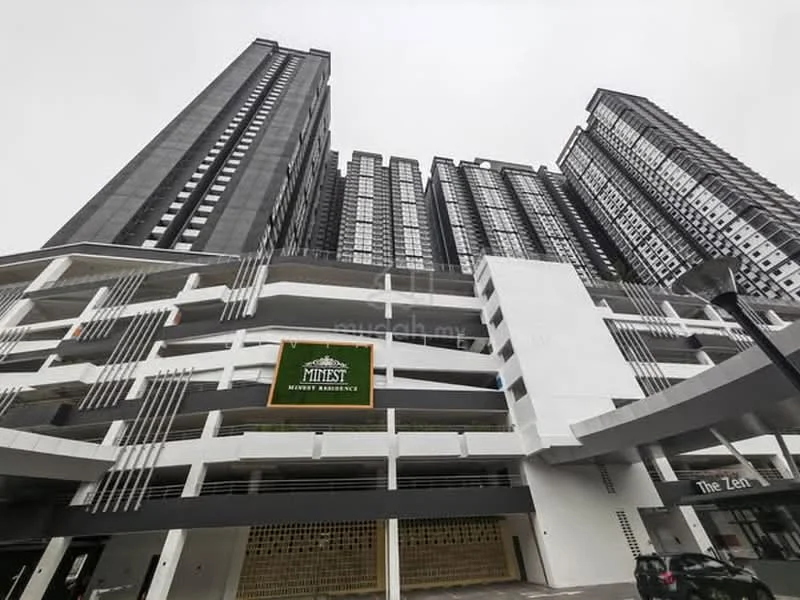 Exterior type: high-rise condominium; features: glass curtain wall, exposed concrete facade, multiple balconies, parking deck, signage for 'Minist', modern architectural design, multi-storey structure, surrounded by urban landscape; style: modern.