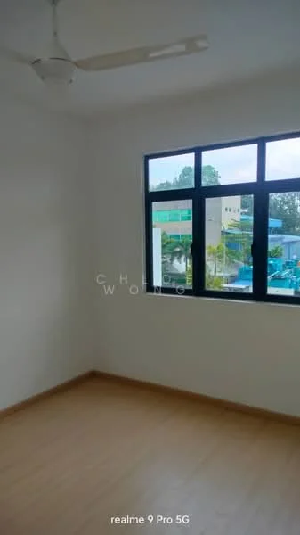 Room features: white painted walls, wooden flooring, ceiling fan, large windows, natural light, corner room, view of surrounding buildings.