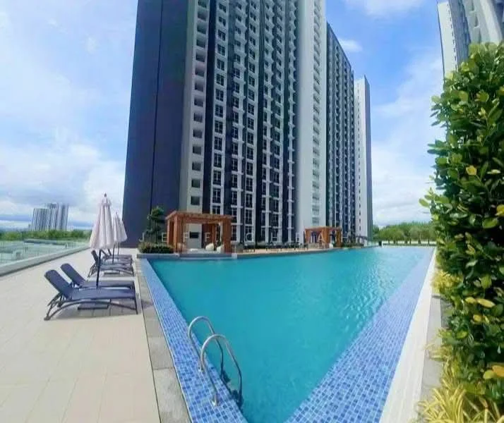 Exterior type: high-rise condominium; features: infinity pool, pool deck with loungers, landscaped garden area, surrounding greenery, modern architectural design, multiple storeys, outdoor umbrellas; style: modern.