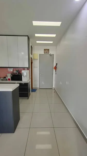 Room features: white painted walls, glossy tile flooring, recessed ceiling lights, kitchen cabinetry with black finish, countertop with island, door leading to hallway, water dispenser, wall-mounted fire extinguisher; style: modern.