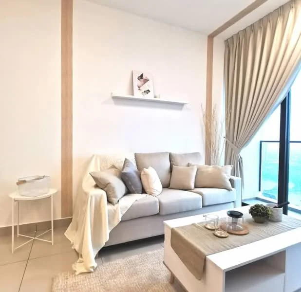 Living features: light grey fabric sofa, decorative cushions in various shades, white side table, beige throw blanket, light wood shelf on wall, floor-to-ceiling window, sheer curtains, neutral wall colour, area rug with soft texture, decorative vase, small black candle holder; style: modern; view: city.
