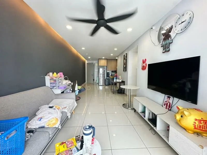 Living features: grey accent wall, white painted walls, white tile flooring, 5-blade ceiling fan with light, sofa in light grey fabric, coffee table, TV console, wall-mounted TV, decorative wall clock, decorative wall art, open shelving unit, basket for storage, snack items on table; style: modern. Kitchen features: kitchen cabinetry, stainless-steel fridge, open layout to living area; style: modern.