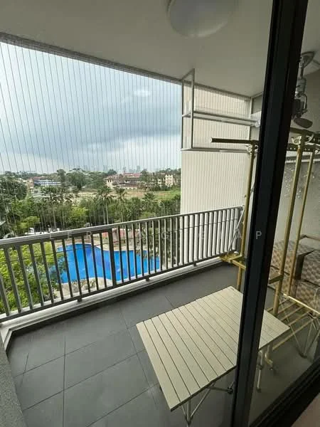 Balcony features: glass sliding door, metal railing, grey tiled flooring, outdoor table, outdoor chairs, view of swimming pool, view of landscaped garden, overcast sky; style: modern; view: pool.