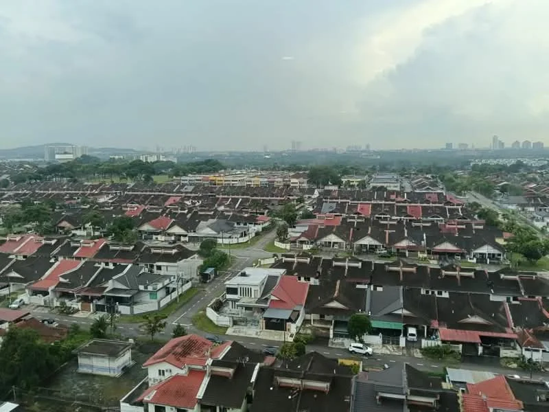Exterior type: linked terrace house; features: red tiled roofs, two-storey houses, manicured lawns, paved driveways, surrounding greenery, urban skyline in background, wide roads, neighborhood layout; style: modern.