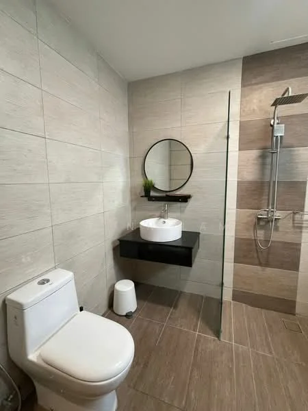 Bathroom features: single-sink vanity with black cabinet, round mirror, glass shower enclosure, rain shower head, handheld shower, one-piece toilet, white ceramic sink, tile cladding on walls, brown and beige accent tiles, wood-look tile flooring, small indoor plant on shelf, wall-mounted faucet; style: modern.