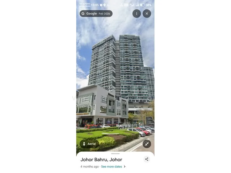 Exterior type: high-rise condominium; features: glass curtain wall, white painted facade, recessed balconies, multiple storeys, commercial space at ground level, landscaped entrance, parking area, surrounded by greenery; style: modern.