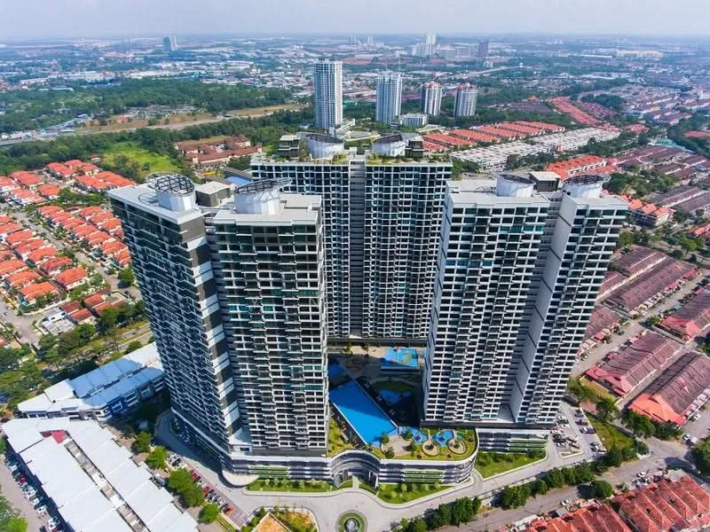 Exterior type: high-rise condominium; features: glass curtain wall, recessed balconies, infinity pool, landscaped garden, pool deck with loungers, children's playground, jogging track, multi-storey car park, surrounded by mature greenery, urban context with residential area in background; style: modern.