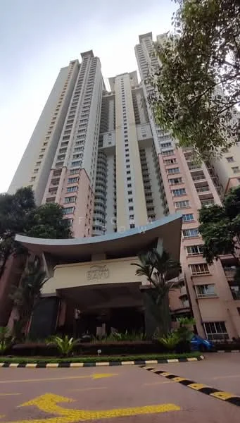 Exterior type: high-rise condominium; features: glass curtain wall, pink painted facade, recessed balconies, landscaped entrance with palm trees, multi-storey structure, main entrance with awning, surrounded by greenery; style: modern.
