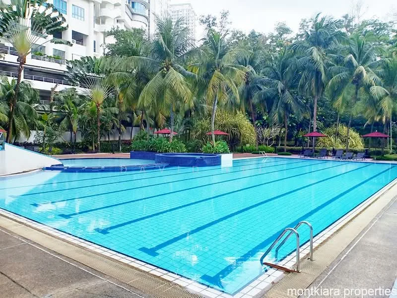 Exterior type: swimming pool deck; features: infinity pool, tiled pool surface, surrounded by palm trees, poolside loungers, red umbrellas, landscaped garden area, concrete pool deck, water features, clear blue water; style: modern.