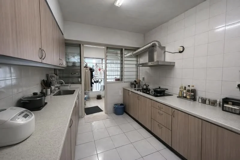 Kitchen features: light wood cabinetry, white countertop, stainless-steel sink, chrome faucet, built-in gas stove, exhaust hood, white tiled walls, white tiled flooring, rice cooker, various cooking utensils, open doorway to utility area; style: modern.