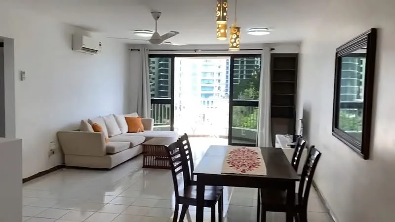 Living features: 3-seater fabric sofa in beige, orange throw pillows, wooden coffee table, dining table with 6 chairs, ceiling fan with light, recessed downlights, floor-to-ceiling sliding glass door, white painted walls, glossy tile flooring, wall-mounted mirror, built-in shelving unit; style: modern; view: city.