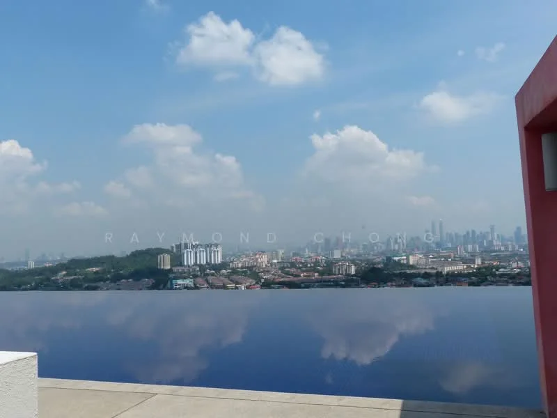 Exterior type: swimming pool deck; features: infinity pool, city skyline view, surrounded by greenery, concrete deck, clear blue sky, clouds reflecting on water; style: modern.