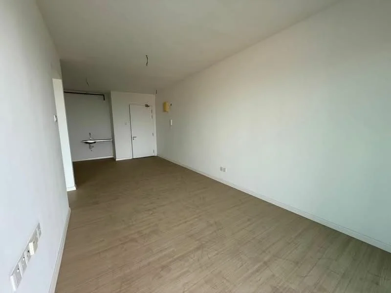 Room features: light wood laminate flooring, white painted walls, no visible furniture, single door, double door, wall-mounted electrical outlets, ceiling with no visible fixtures; style: minimalist.