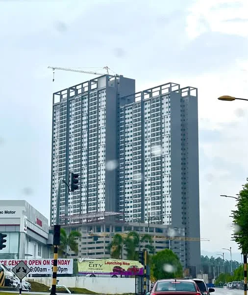 Exterior type: high-rise condominium; features: glass curtain wall, grey painted facade, recessed balconies, approximately 20-storey high-rise, construction crane visible, surrounded by palm trees, signage for property launch, manicured landscaping; style: modern.