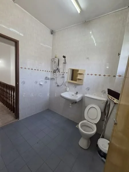 Bathroom features: white tiled walls, grey tiled flooring, single-sink vanity with mirror, toilet, shower with wall-mounted faucet, wall-mounted showerhead, built-in shelf, light fixture on ceiling.