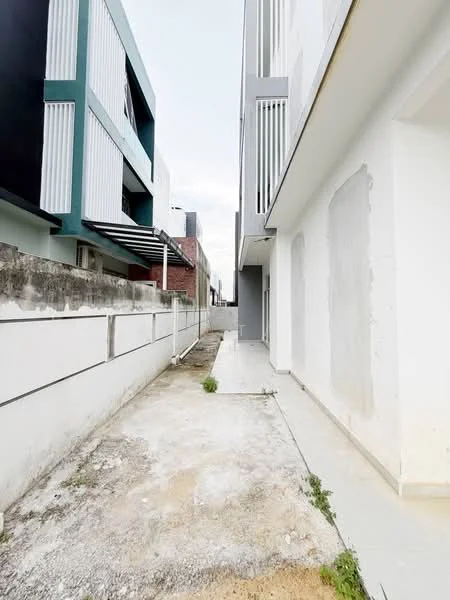 Exterior features: narrow pathway, concrete flooring, white painted walls, grey painted walls, adjacent buildings, minimal landscaping, exposed foundation, fencing along the pathway; style: modern.