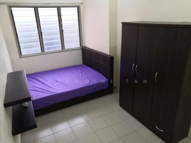 Bedroom features: single bed with purple bedding, dark wood headboard, built-in wardrobe with sliding doors, wall-mounted shelf, white painted walls, tile flooring, window with horizontal blinds, natural light from window.