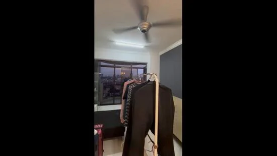 Room features: ceiling fan, floor-to-ceiling windows, curtains, clothes rack, dark accent wall, light-colored walls, tile flooring, city view; style: modern; view: city.
