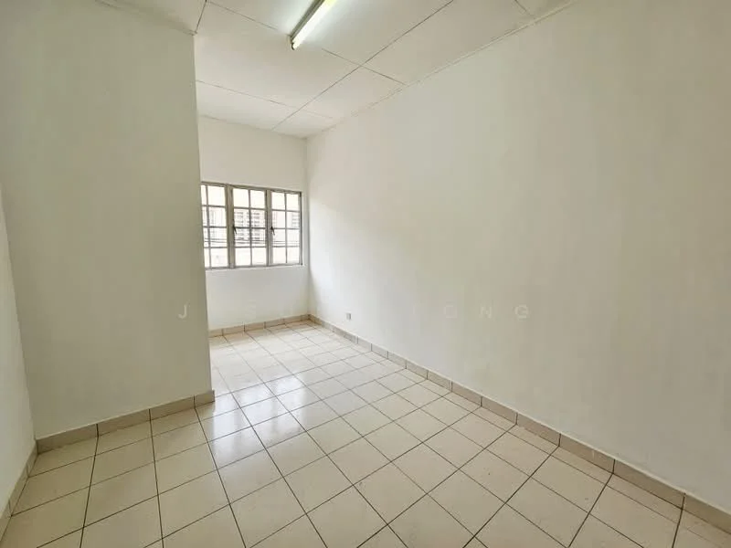 Room features: white painted walls, tile flooring, square grid ceiling, window with multiple panes, neutral color scheme, no visible furniture, single light fixture, corner room; style: minimalist.