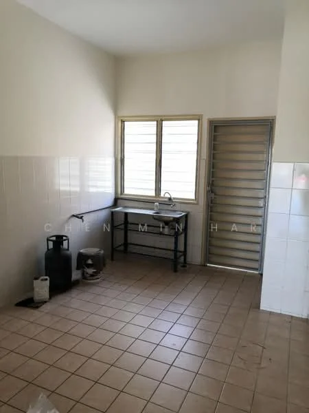 Laundry features: single-bowl stainless-steel sink, chrome faucet, black metal table, white tiled walls, cream painted walls, brown tiled flooring, window with metal grille, door with metal grille, gas cylinder, washing machine connection.