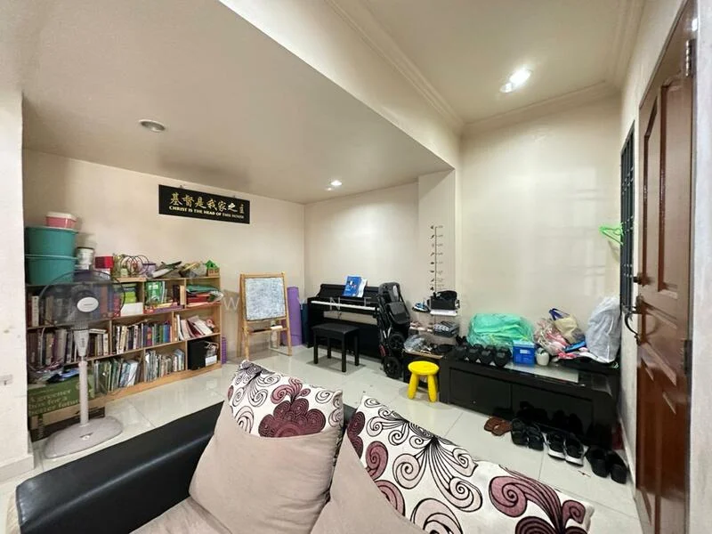 Room features: cream painted walls, white ceiling, recessed downlights, tile flooring, bookshelf with books, piano, fan, black chair, green bags, yellow stool, shoes on the floor.