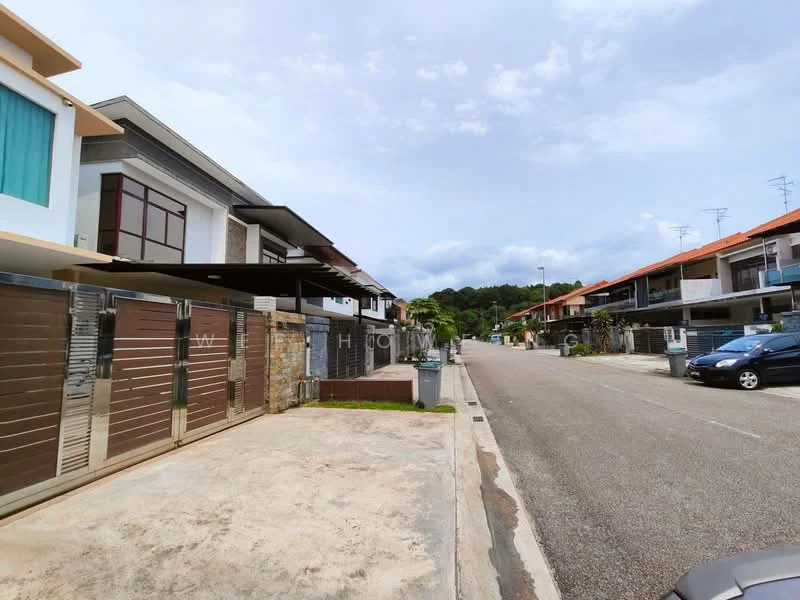 Exterior type: linked terrace house; features: two-storey linked terrace houses, modern facade with a mix of materials, driveway with interlocking pavers, manicured lawn, street view with parked cars, surrounded by greenery, clear blue sky, paved walkway; style: modern.