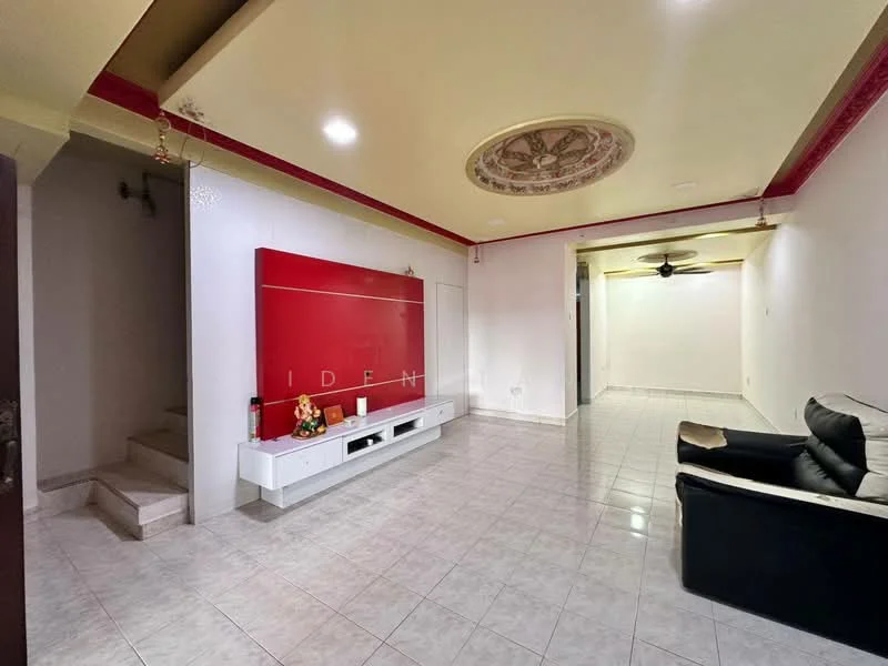 Living features: white painted walls, glossy tile flooring, tray ceiling with decorative design, red accent wall, black leather sofa, TV console with storage, ceiling fan, staircase leading to upper floor; style: modern.