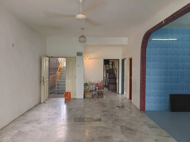 Room features: marble flooring, white painted walls, ceiling fan, open layout, staircase visible in background, blue tiled wall, doorway leading to another room, natural light from windows; style: modern.