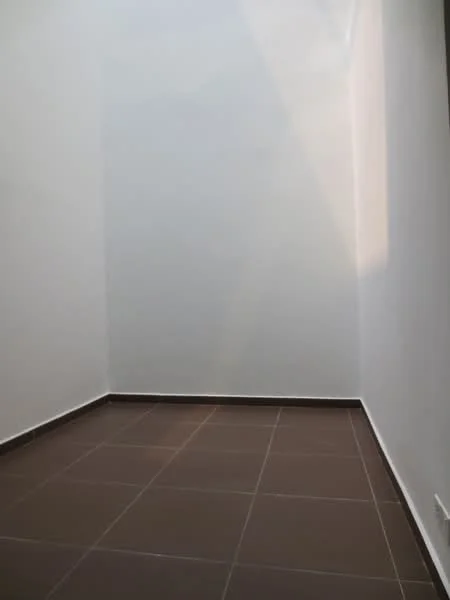 Room features: white painted walls, brown ceramic tile flooring, natural light from window.