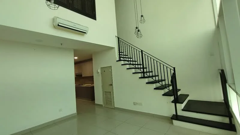 Room features: white painted walls, grey tiled flooring, black metal staircase, 1 wall-mounted split AC, hanging pendant lights, open layout, door to kitchen area, high ceiling; style: modern.