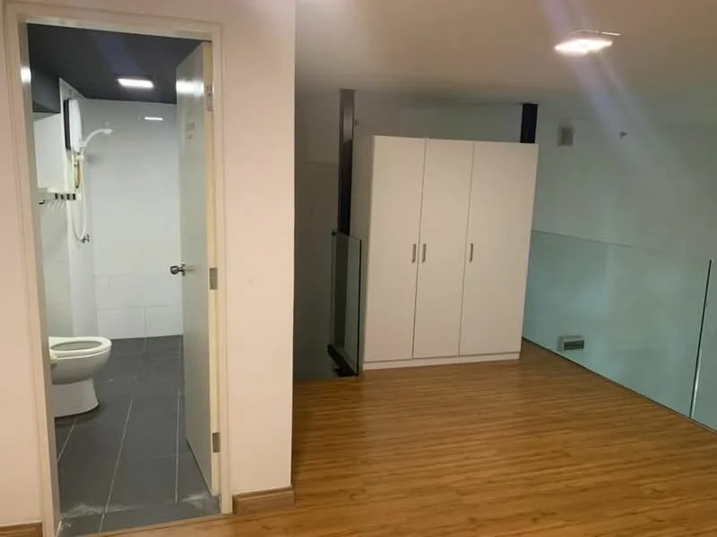 Room features: wood laminate flooring, white painted walls, glass railing, built-in wardrobe with sliding doors, recessed downlights, bathroom with white tiled walls, toilet, shower fixture, grey tiled flooring in bathroom; style: modern.