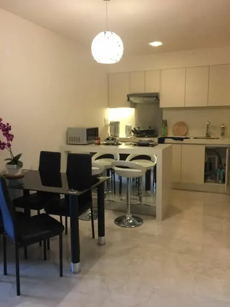 Kitchen features: white cabinetry, black dining table, 4 black dining chairs, white bar stools, stainless-steel sink, chrome faucet, built-in oven, stove with hood, microwave, light-colored marble flooring, pendant light fixture, decorative orchid plant; style: modern.