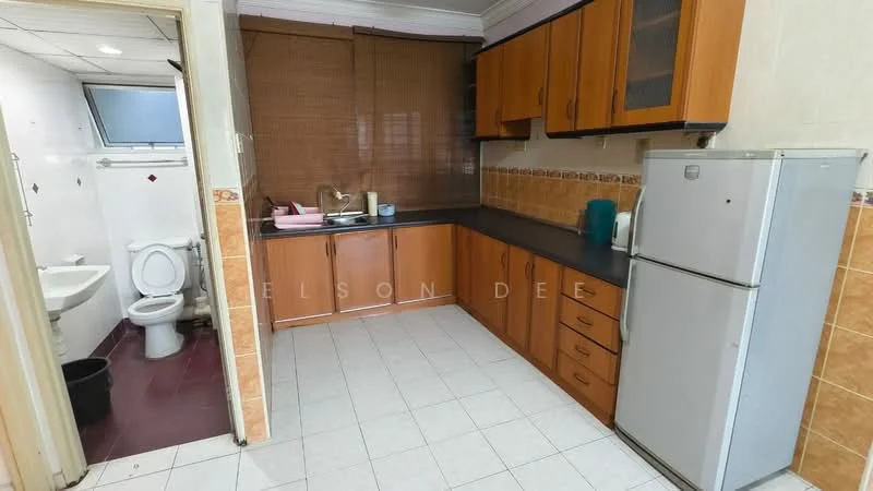 Kitchen features: brown wooden cabinetry, black countertop, stainless-steel fridge, single-bowl stainless-steel sink, chrome pull-down faucet, ceramic tile flooring, wall-mounted cabinets, window with sheer curtains. Bathroom features: one-piece toilet, white tiled walls, ceramic tile flooring, sink with chrome faucet, mirror above sink, shower area with glass partition.