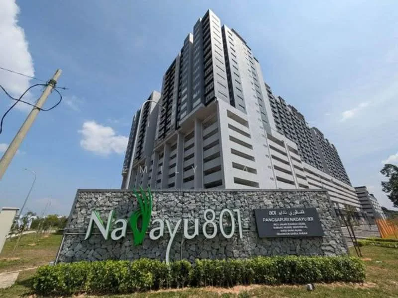 Exterior type: high-rise condominium; features: grey concrete facade, glass curtain wall, recessed balconies, landscaped entrance, signage with name 'Nadayu801', surrounding greenery, multiple storeys, modern architectural design; style: modern.