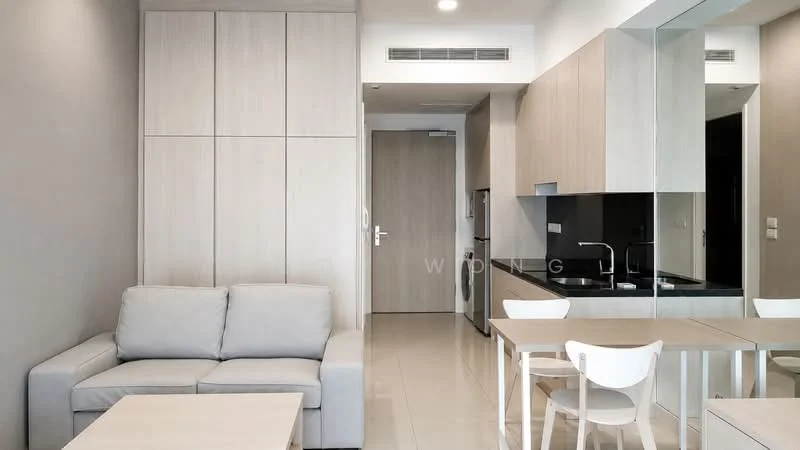 Living features: light grey fabric sofa, white dining table, four white dining chairs, kitchenette with black countertop, stainless-steel fridge, built-in cabinetry with light wood finish, mirror backsplash, cream tiled flooring, recessed downlights, wall-mounted air conditioning unit, neutral painted walls; style: modern.