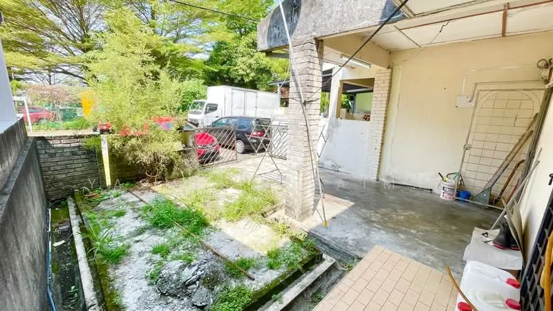 Exterior type: linked terrace house; features: concrete flooring, brick wall, fenced yard, overgrown grass, paved walkway, outdoor space, adjacent parking area, surrounded by greenery; style: modern.