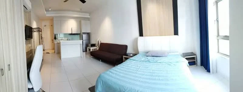 Room features: queen-size bed with upholstered headboard, light blue bedding, white walls, tile flooring, sofa in brown fabric, white dining chair, wall-mounted TV, kitchenette with white cabinetry, stainless-steel fridge, kitchen counter with bar stools, ceiling fan, large windows with blue curtains; style: modern; view: city.