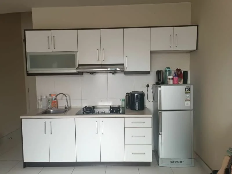 Kitchen features: white cabinetry with flat-panel doors, stainless-steel sink, chrome pull-down faucet, 2-burner gas hob, built-in range hood, white tiled backsplash, countertop with light-colored surface, stainless-steel fridge, black kettle, black coffee machine, white ceramic mug, glass water bottle; style: modern.