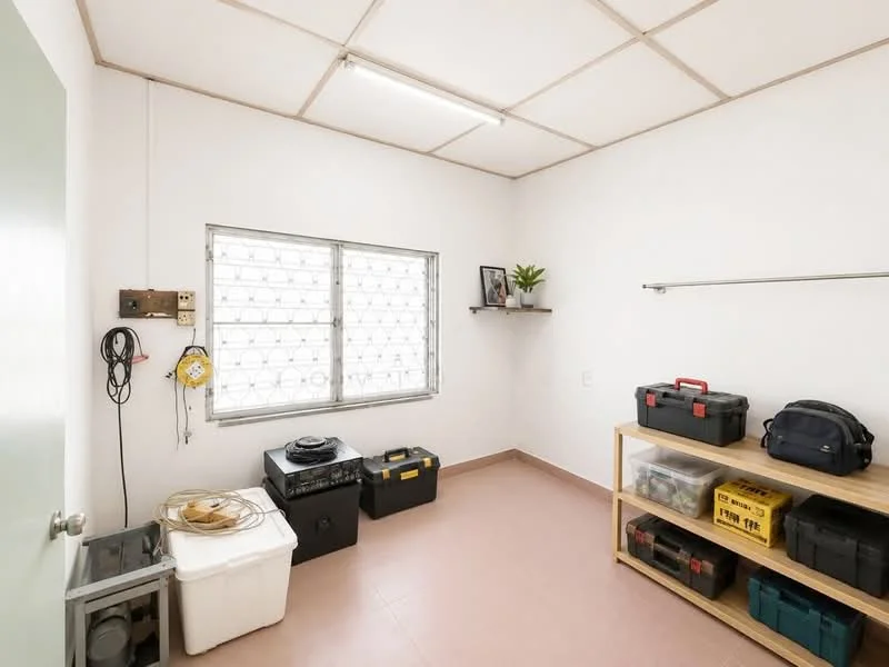 Room features: white painted walls, tile flooring, window with security grille, shelf with potted plant, wooden shelving unit, plastic storage bins, toolboxes, cable management, overhead lighting, power outlet; style: minimalist.