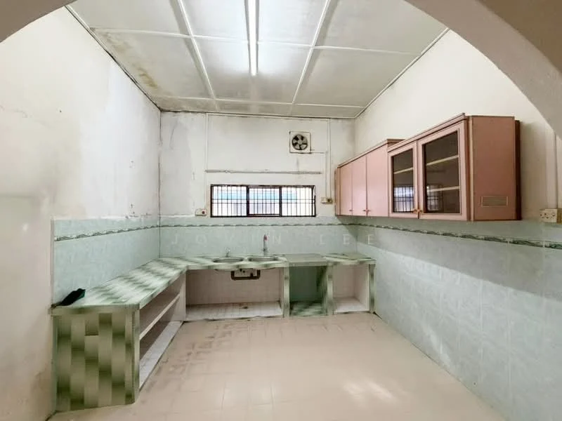 Kitchen features: green tiled backsplash, white tiled walls, pink cabinetry with glass fronts, single-bowl sink, wall-mounted exhaust fan, countertop with integrated storage, floor tiles, window with metal grille.