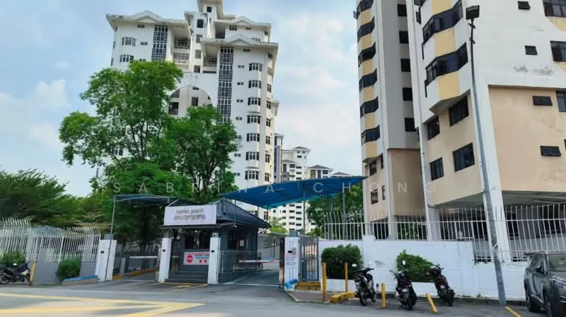 Exterior type: mid-rise condominium; features: white painted facade, black window frames, gated entrance, security guard house at entrance, manicured landscaping, surrounded by mature greenery, driveway with interlocking pavers, multiple storeys, balconies visible on upper floors; style: modern.