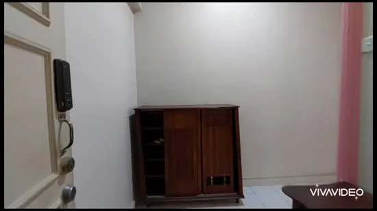 Room features: white painted walls, light-colored flooring, wooden cabinet, door with electronic lock, baseboard, corner of the room.