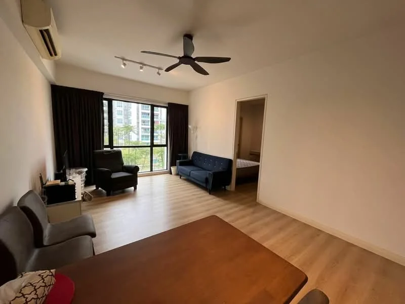 Living features: laminate flooring, white painted walls, 5-blade ceiling fan, floor-to-ceiling windows, blackout curtains, sofa in blue, 2-seater fabric sofa in grey, wooden dining table, TV console, decorative plants, natural light from windows; style: modern; view: garden. Room features: doorway leading to another room, neutral wall color, visible light from hallway.