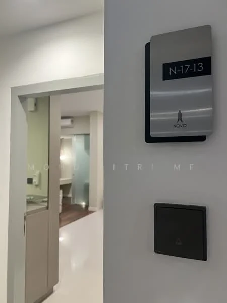 Room features: white painted walls, glossy tile flooring, door frame, light switch, room number sign, visible doorway leading to another room, air conditioning unit, recessed lighting; style: modern.