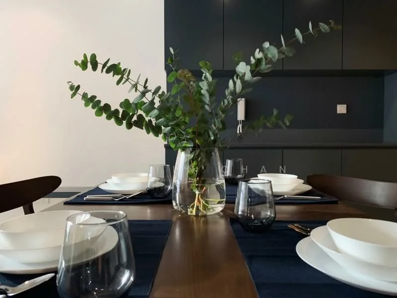 Dining features: dark cabinetry, wood dining table, white dinner plates, glass drinking glasses, eucalyptus centerpiece, blue table runner, cutlery, modern pendant light, wall-mounted light fixture; style: modern.