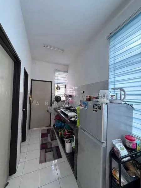 Kitchen features: white painted walls, glossy tile flooring, single-door fridge, metal shelving unit, kitchen sink, countertop with various kitchen appliances, window with blinds, door leading to another room, rug with geometric pattern.