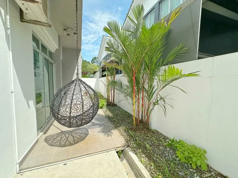 Exterior features: hanging wicker chair, paved walkway, landscaped garden, tropical plants, white painted walls, grey exterior wall, sunlight casting shadows, fence, sliding glass door; style: modern.