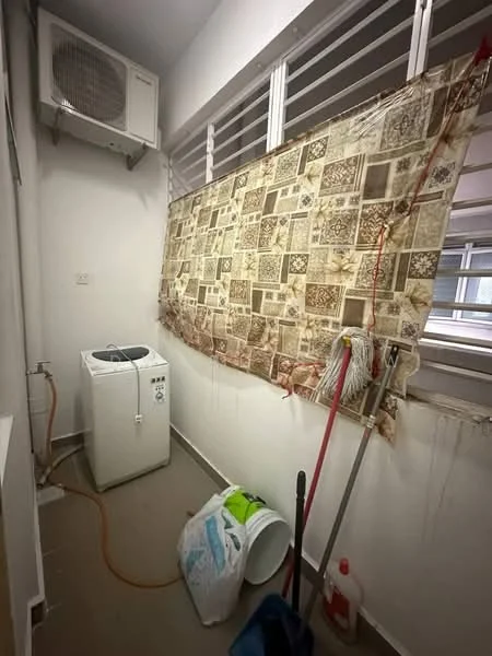 Laundry features: front-load washing machine, 1 wall-mounted split AC, tile flooring, white painted walls, window with horizontal slats, cleaning supplies, bucket, mop, detergent bottle.