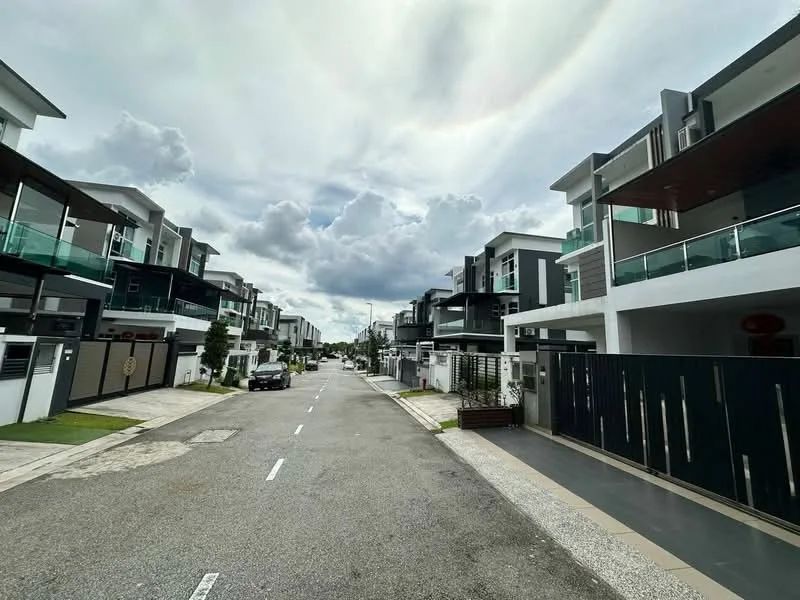 Exterior type: linked terrace house; features: two-storey houses, glass balcony railings, modern facade with dark cladding, manicured lawns, paved driveway, street lined with trees, cloudy sky, sidewalks, visible car parked on the street; style: modern.