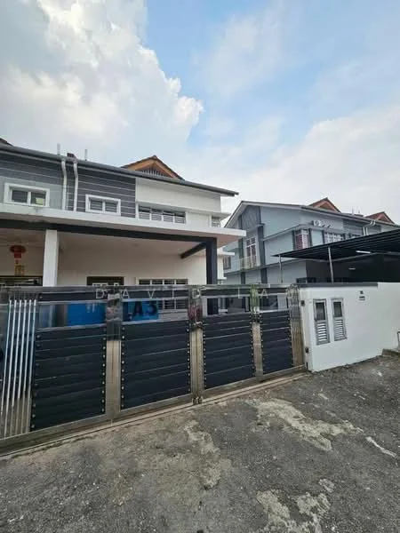 Exterior type: linked terrace house; features: grey painted facade, two-storey building, gated entrance with metal gate, roof with overhang, multiple windows, driveway with gravel surface, adjacent building visible, clear sky, urban setting; style: modern.